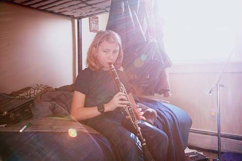 musical instrument woman in black shirt playing flute oboe